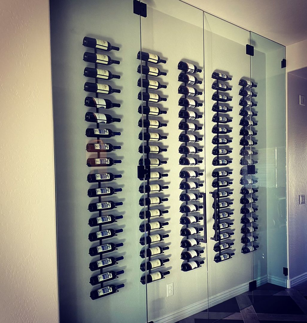 Glass-enclosed wine room with wall-mounted bottle racks