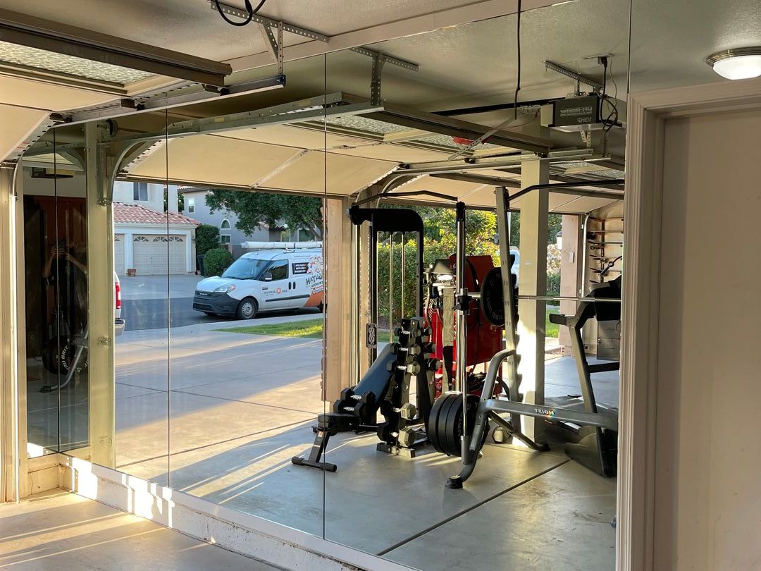Full-height mirror wall in a garage home gym