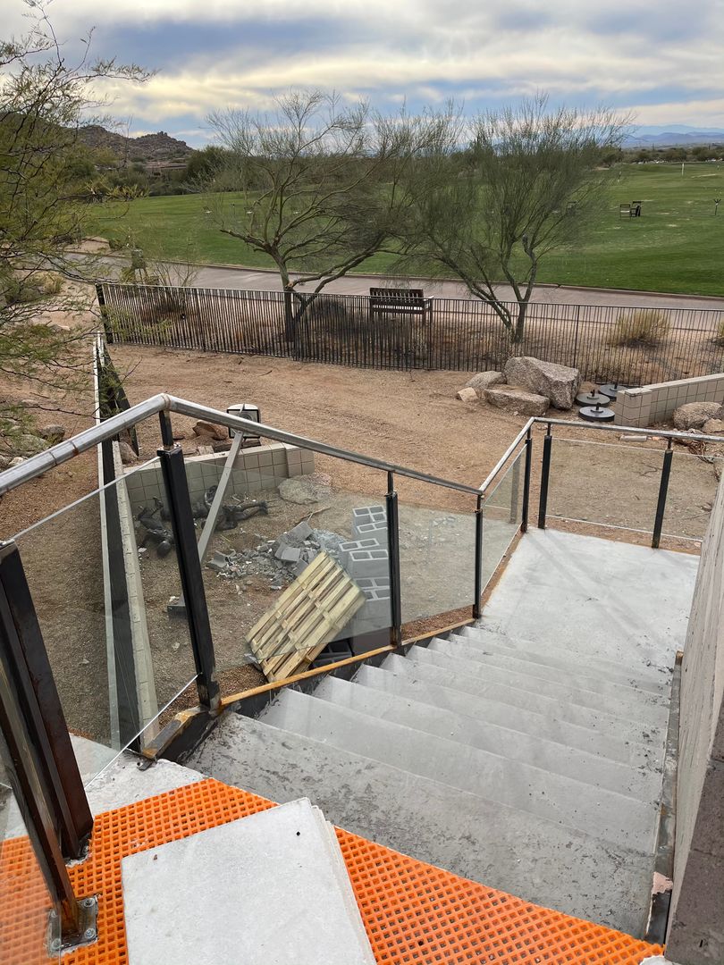 Interior glass stair railing with metal handrail in a Scottsdale home