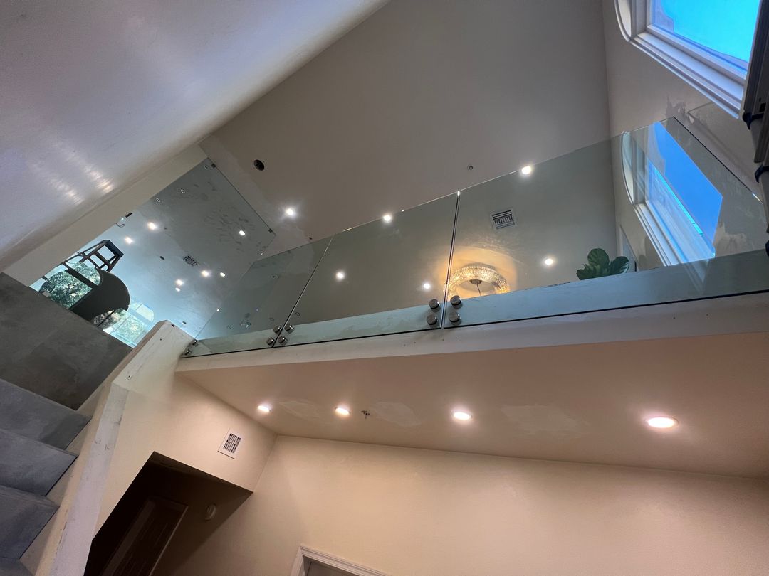 Frameless glass railing along an upper-floor landing
